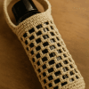 Crochet water bottle holder pattern in cream cotton with mesh design
