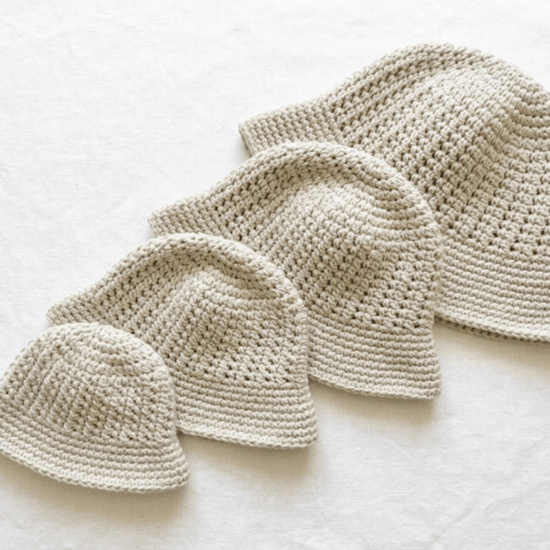 Beginner crochet bucket hat pattern PDF with cotton yarn and crochet hook flat lay Beginner crochet bucket hat pattern PDF with cotton yarn and crochet hook flat lay