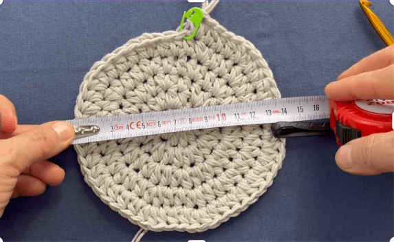 Crochet bucket hat flat lay — crown view showing seamless construction and stitch texture