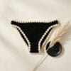 Flat-lay of the finished crochet book thong on neutral linen background