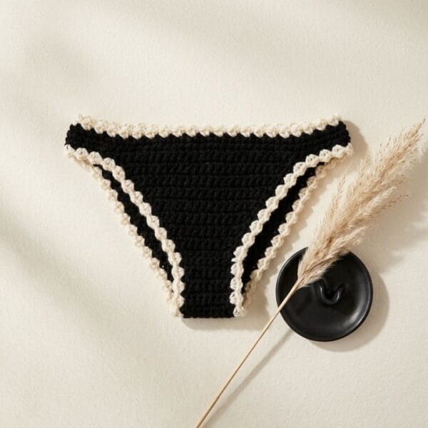Flat-lay of the finished crochet book thong on neutral linen background