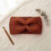 crochet ear warmer pattern flat lay in rust terracotta